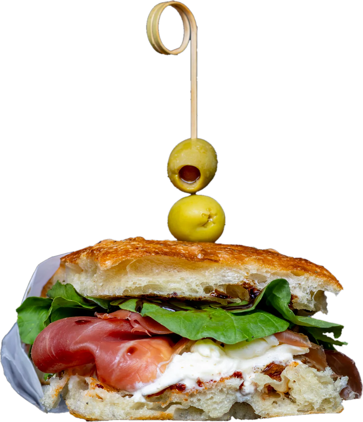Focaccia sandwich with prosciutto, greens and cheese, topped with two olives on a pick