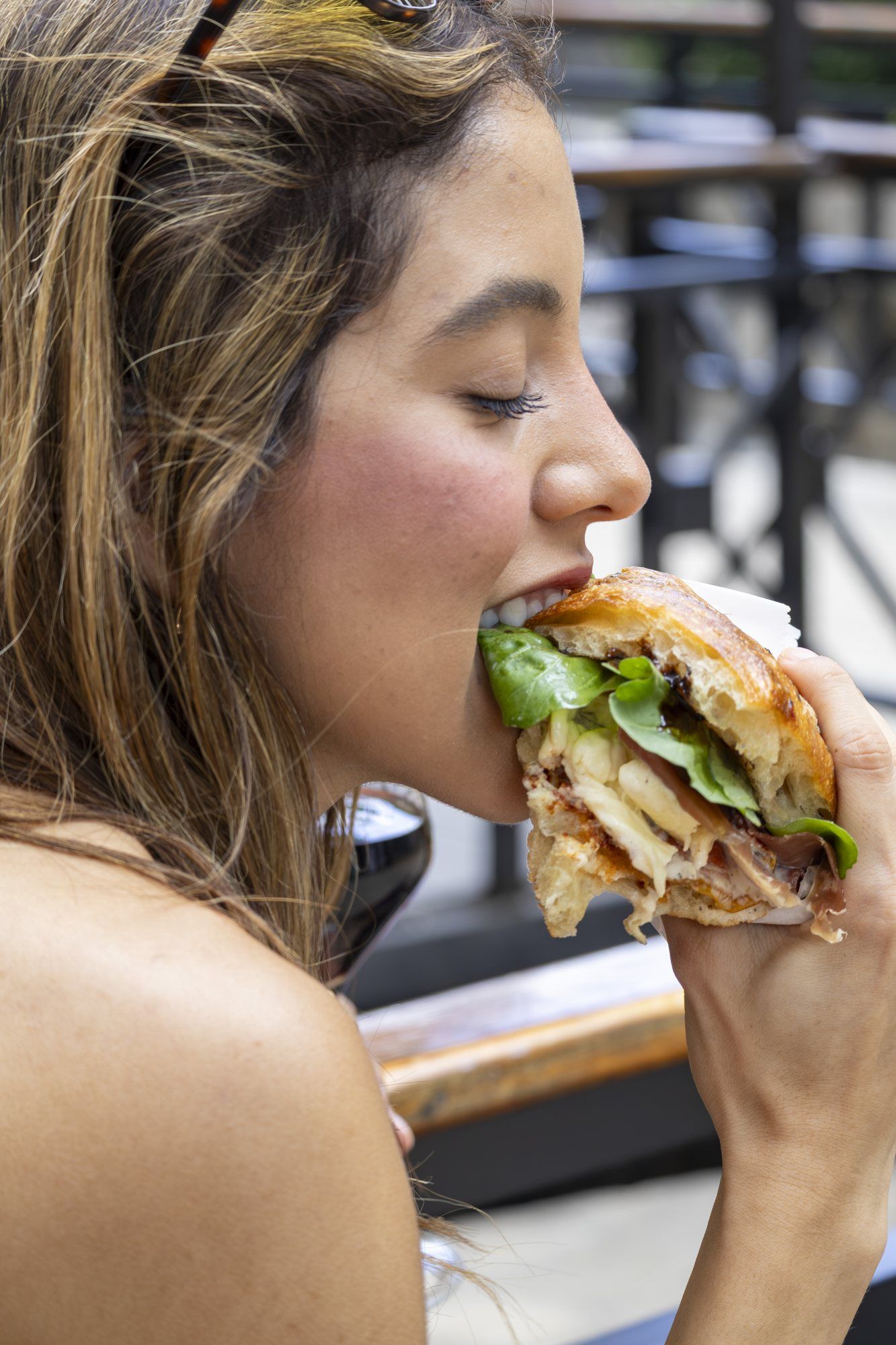 Close-up of someone taking a bite of focaccia