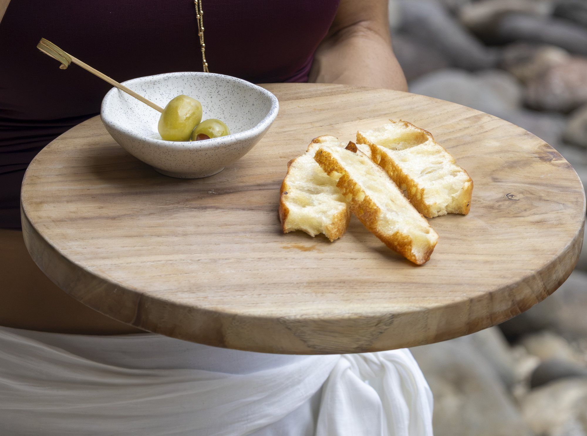 Wooden board with olives and toasted focaccia